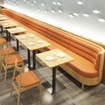 Custom orange upholstered restaurant banquette seating with wooden dining tables for cafe interior - Maylo Furniture