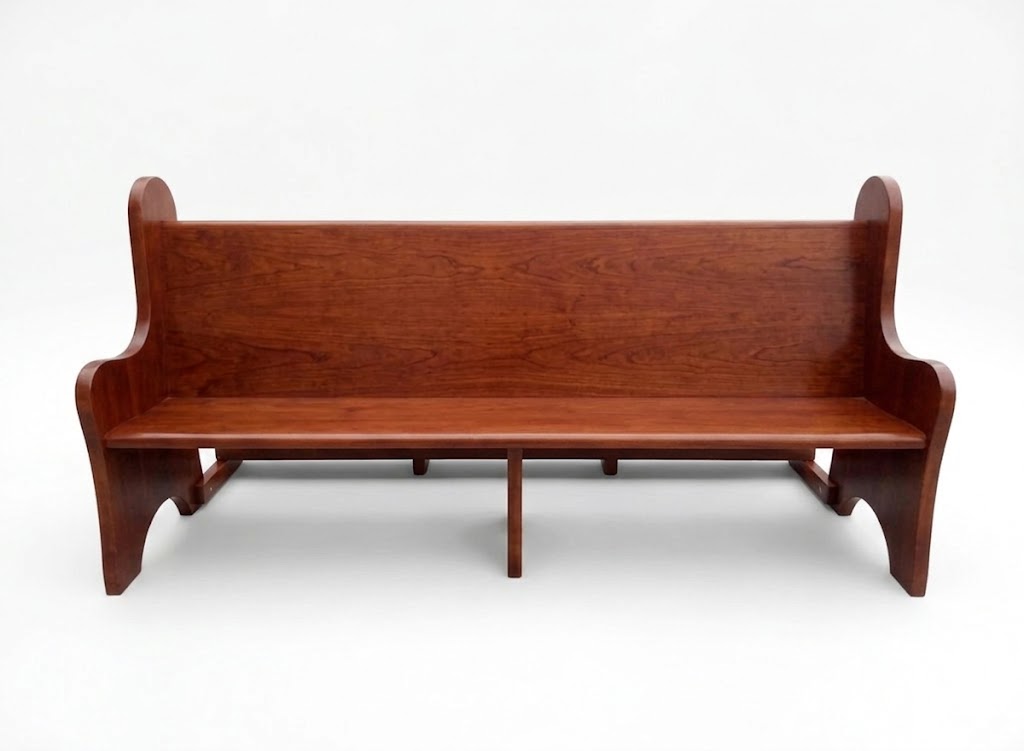Custom solid wood church pew bench with elegant carved ends and warm wood finish - Maylo Furniture